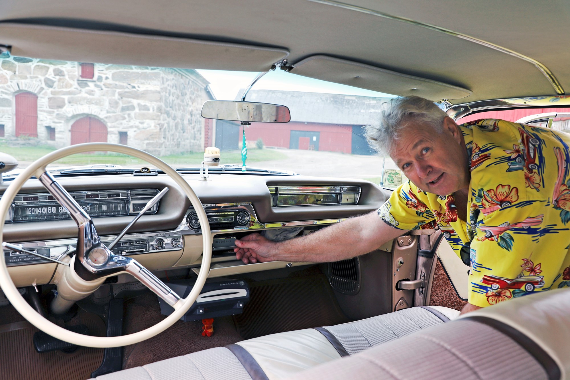 Stefan demonstrerar den transportabla radion som förvaras i handskfacket. Den har även en anslutning till den ordinarie radion i panelen.